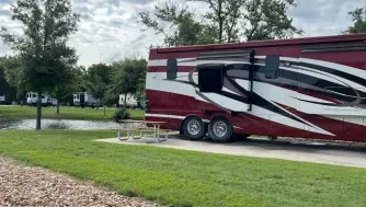 RV on concrete next to a grass lawn