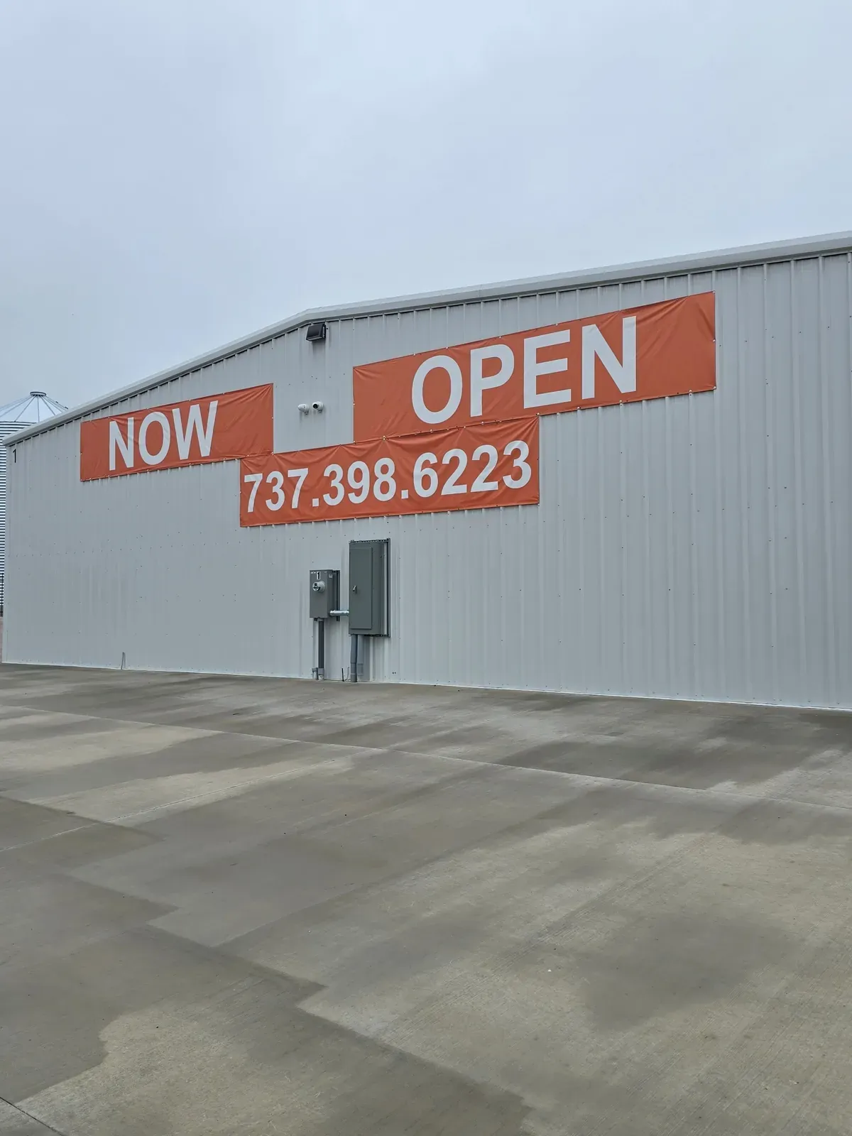 Storage facility exterior with a now open sign