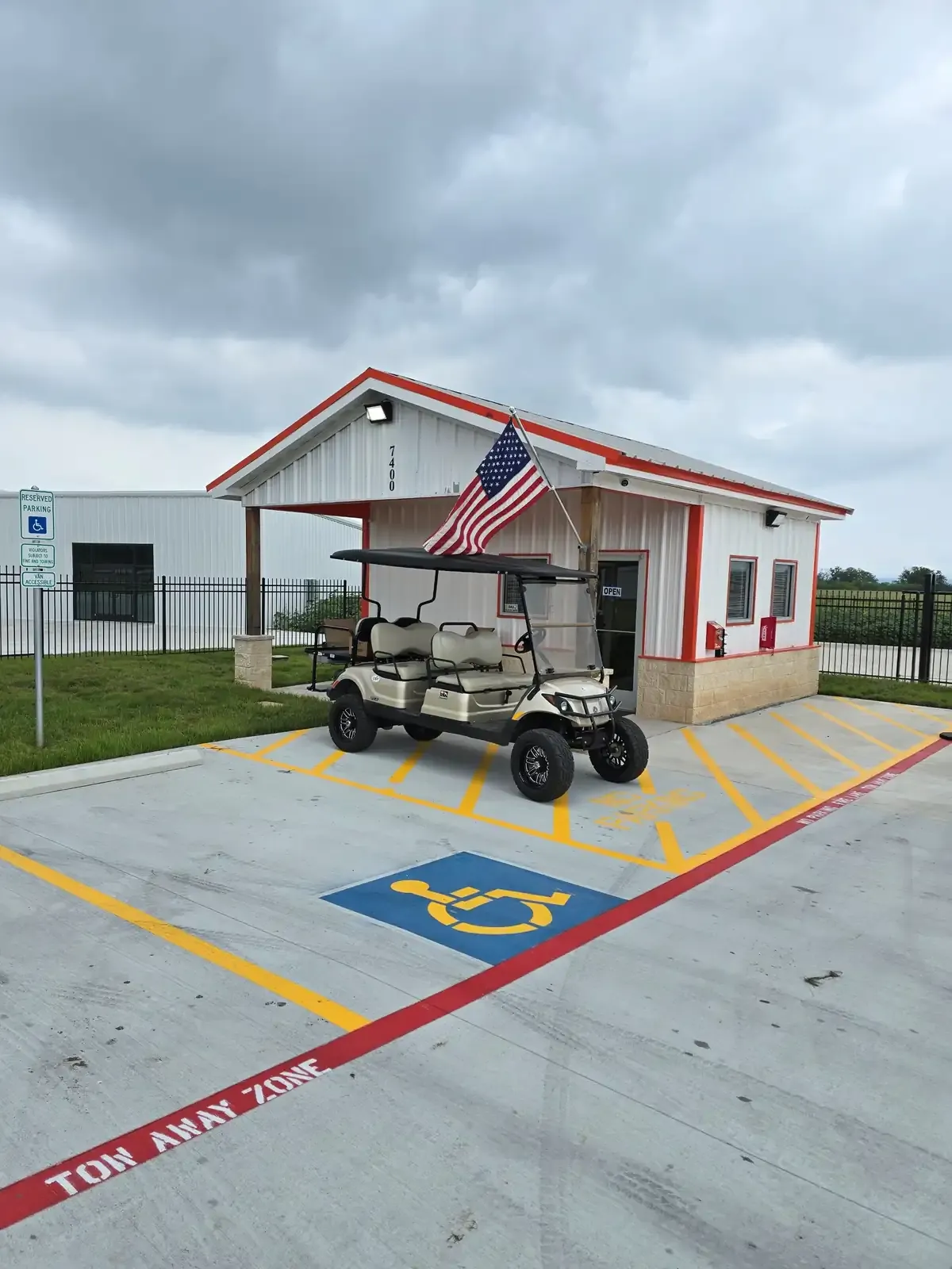 Office of a storage facility exterior with a golf cart