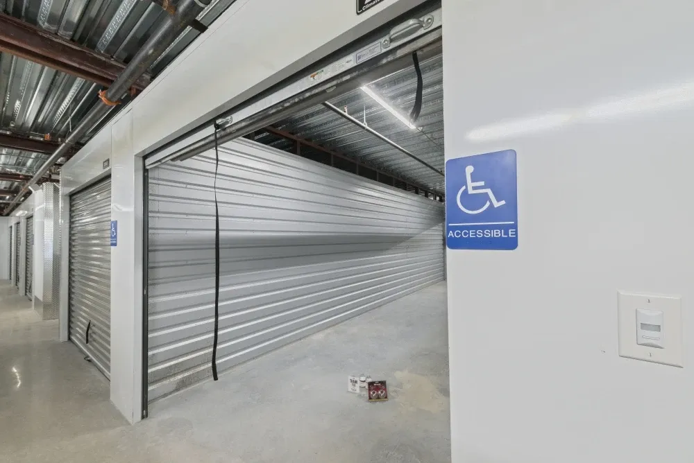 Indoor, climate-controlled storage unit with accessibility sign on the exterior.