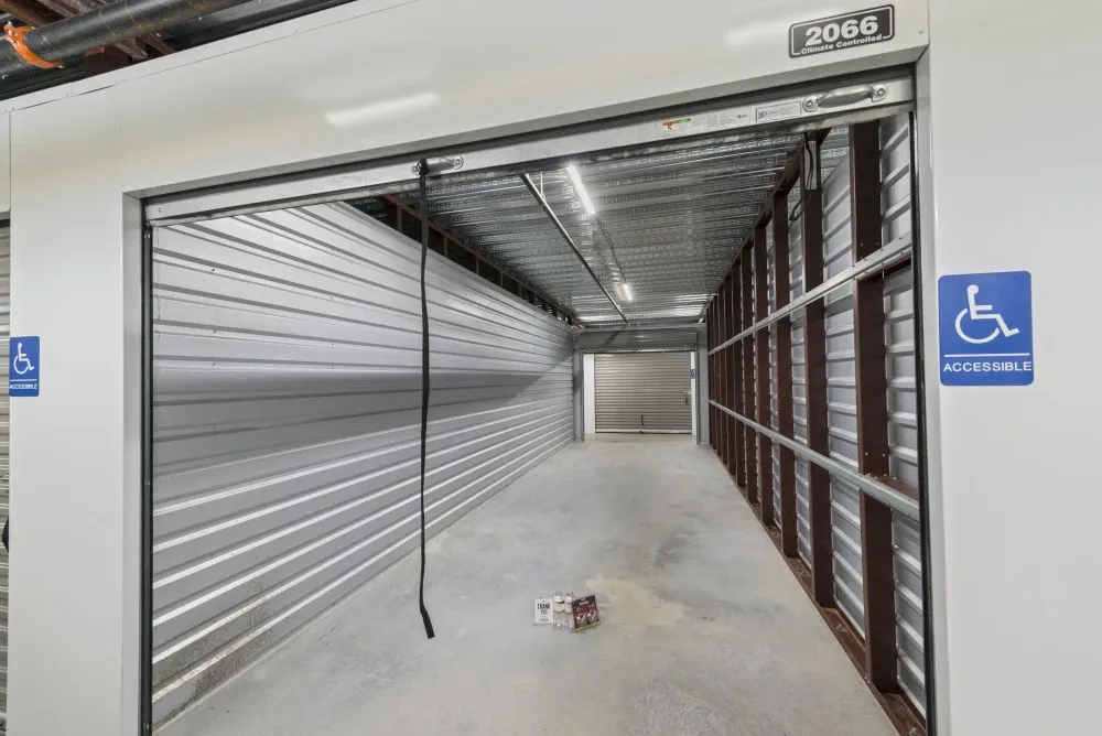 Indoor, climate-controlled storage unit with accessibility sign on the exterior.