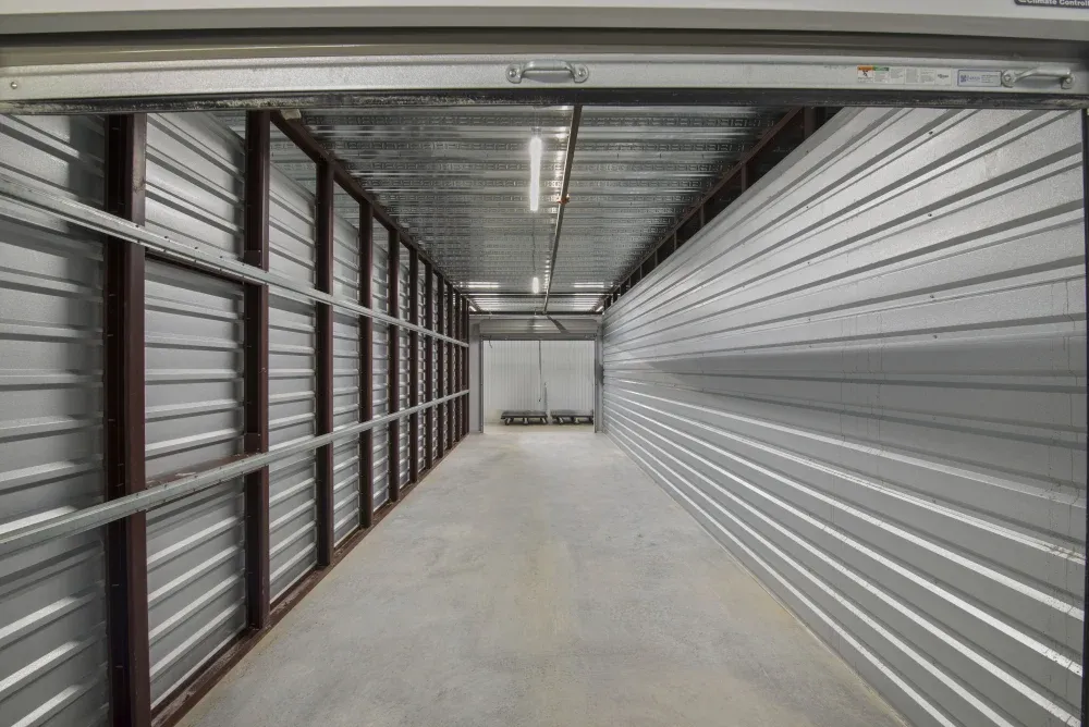 Hallway of accessible climate-controlled storage units with moving carts for use.