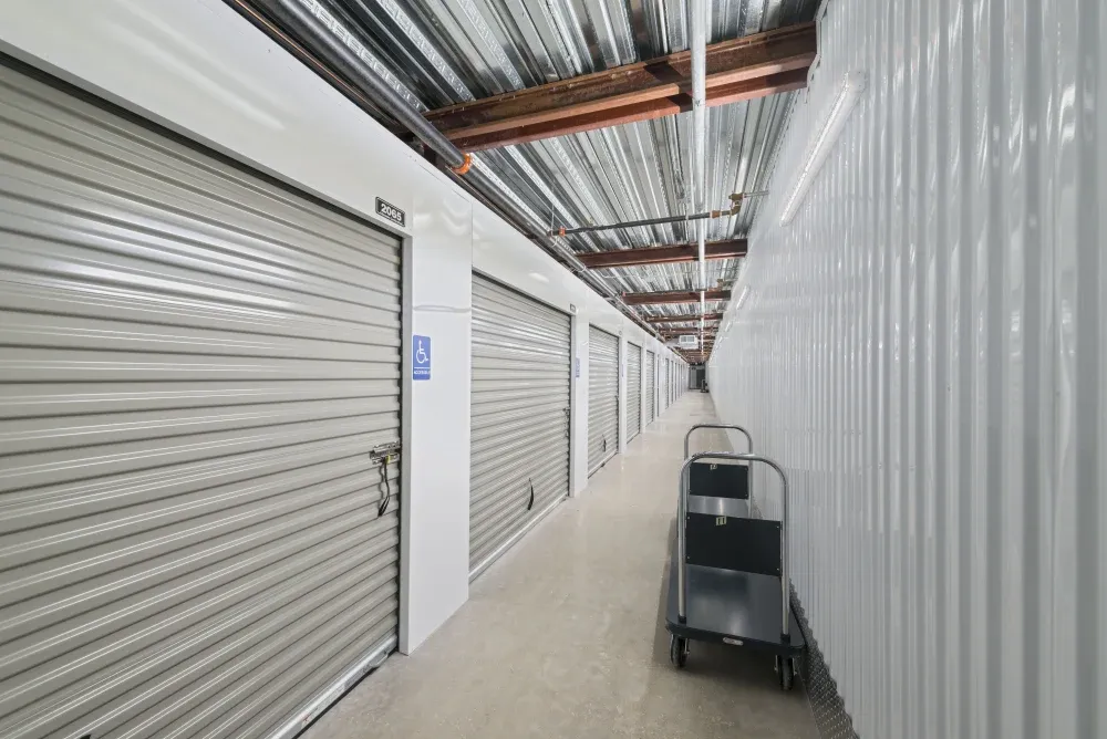 Hallway of accessible climate-controlled storage units with moving carts for use.
