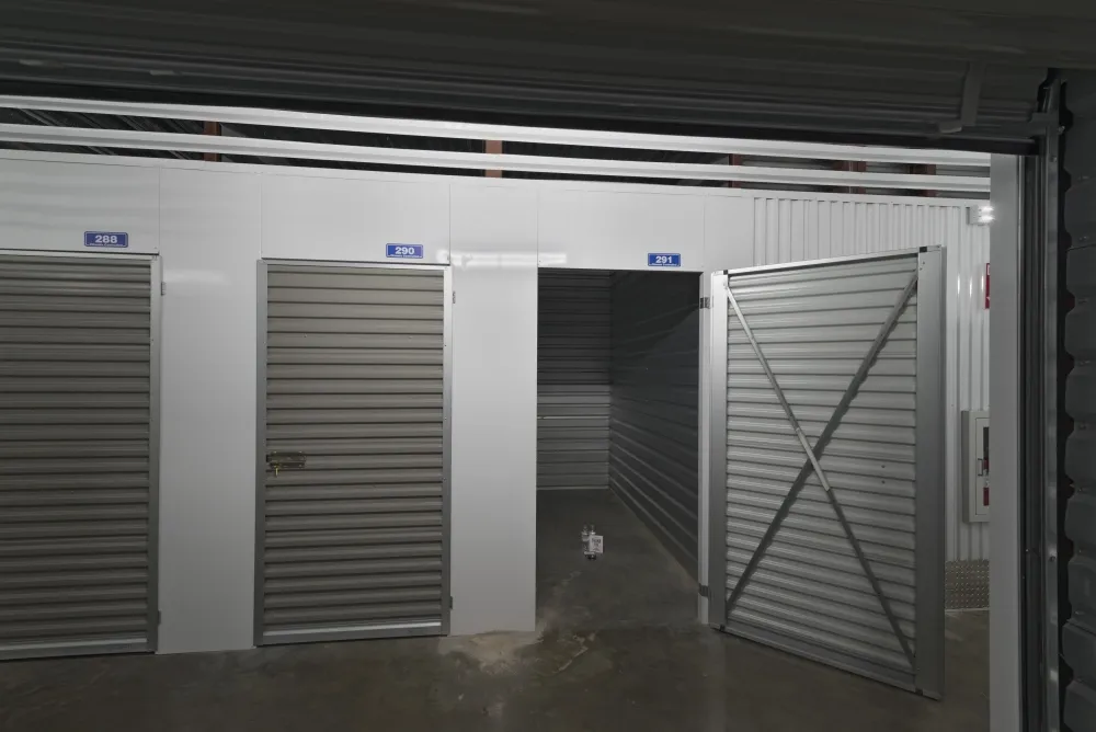 Indoor storage units with an open door at EaDo Storage facility.