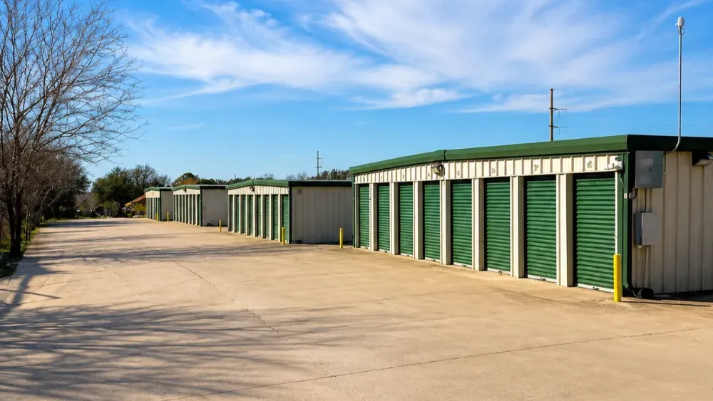 Storage facility exterior with green rollup doors