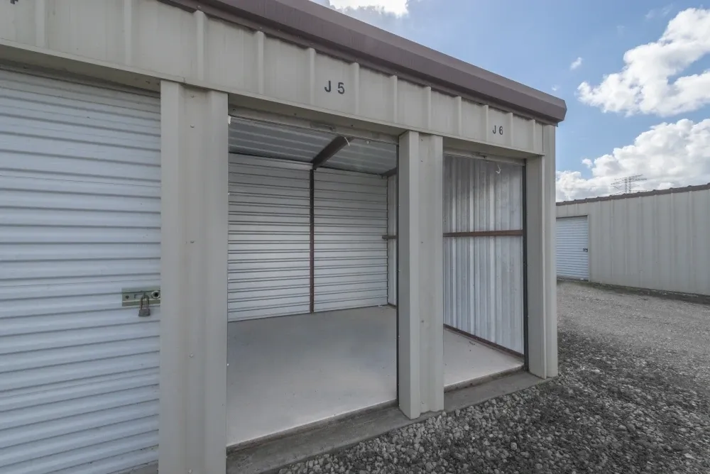 Outdoor storage units with drive-up access and open door at Guardian Storage.