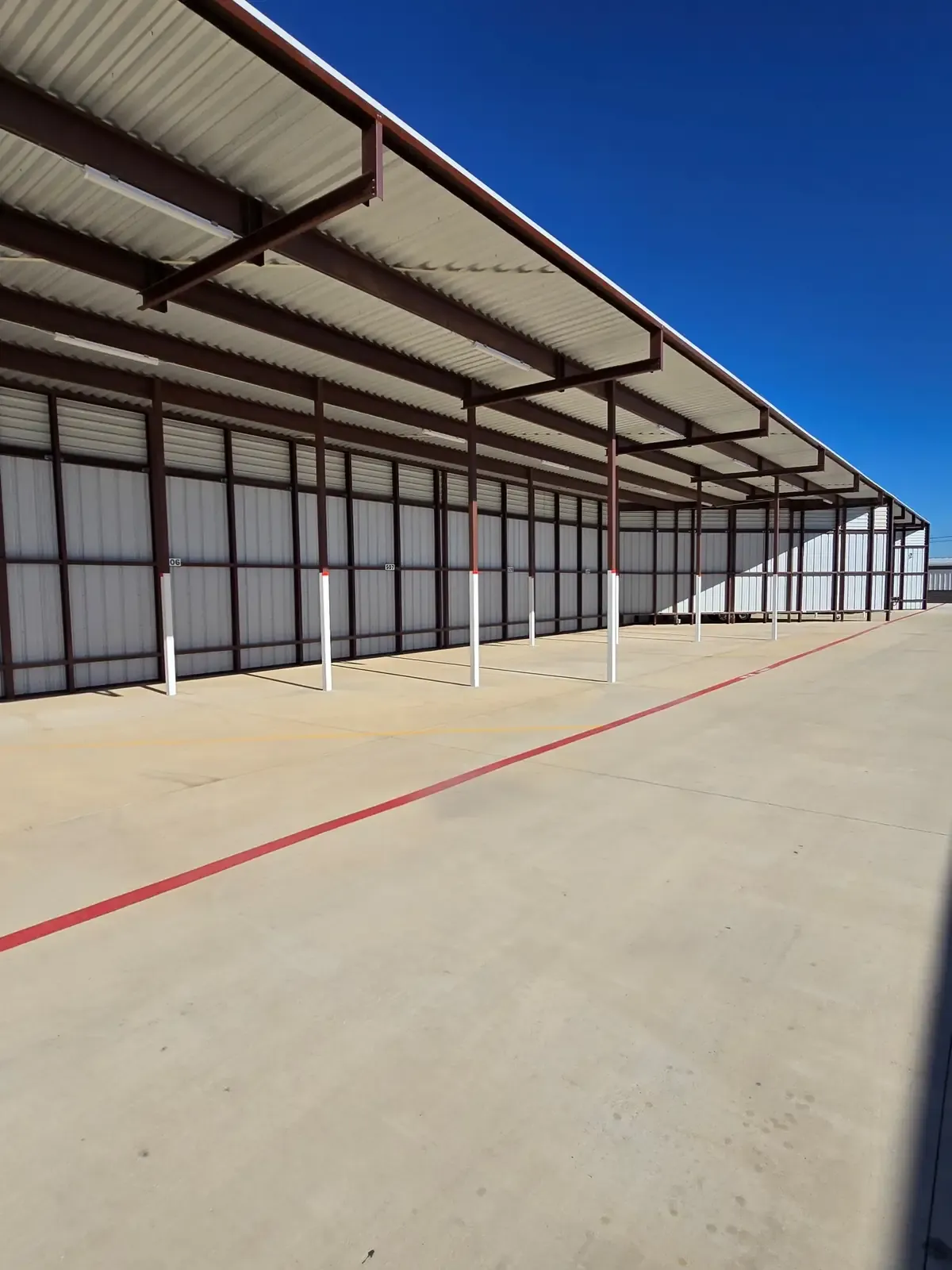Concrete paved covered parking at a self storage facility.