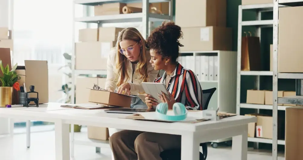Two women looking at clipboard