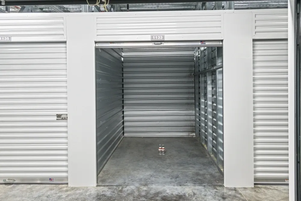 Opened small, climate-controlled storage unit with roll-up doors at Valley Ranch Storage.